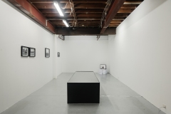 Alannah Dair, installation view of 'Black Bile II,' 2025, Engine oil, iron oxide, neodymium magnets, motors, proximity sensor, arduino uno, aluminium and wood.